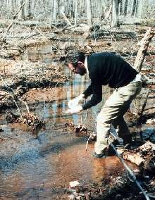 a scientist collecting acid rain
